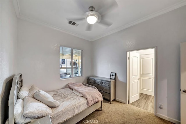bedroom featuring crown molding, visible vents, ceiling fan, baseboards, and light carpet