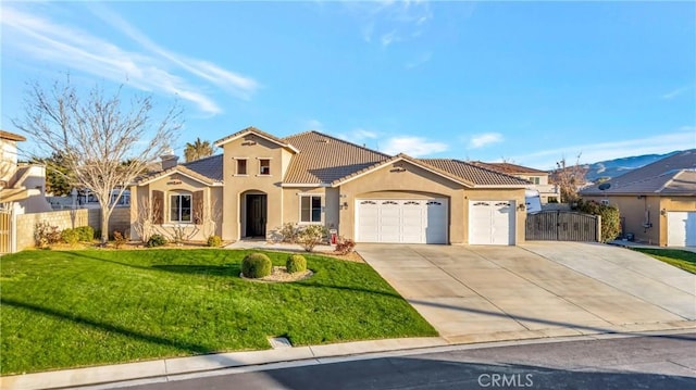 mediterranean / spanish home featuring stucco siding, a garage, driveway, and a tile roof