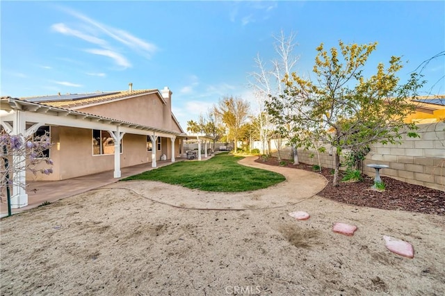 view of yard featuring a patio and a fenced backyard