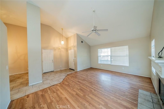 unfurnished living room featuring visible vents, ceiling fan, high vaulted ceiling, and wood finished floors
