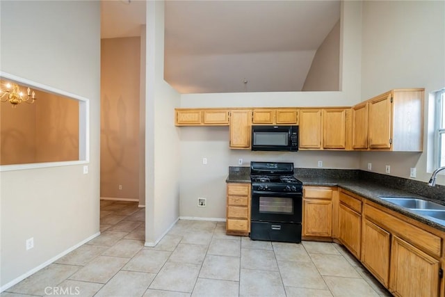kitchen featuring light tile patterned flooring, a sink, black appliances, and dark countertops