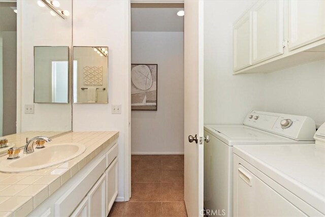 233 Lake Shore Dr, Rancho Mirage, CA 92270 - washroom with a sink, washing machine and dryer, tile patterned flooring, and baseboards