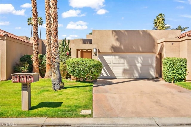 233 Lake Shore Dr, Rancho Mirage, CA 92270 - adobe home featuring an attached garage, driveway, stucco siding, and a front lawn