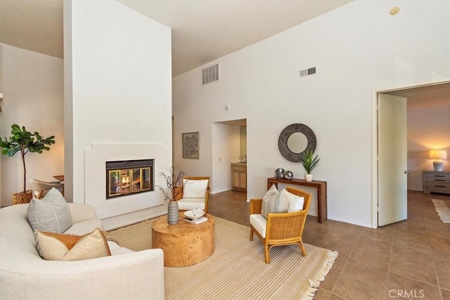 233 Lake Shore Dr, Rancho Mirage, CA 92270 - living room with a towering ceiling, a glass covered fireplace, and tile patterned flooring