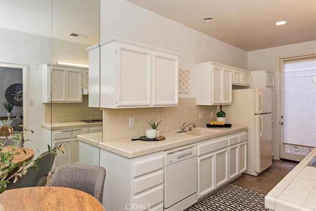 233 Lake Shore Dr, Rancho Mirage, CA 92270 - kitchen featuring white appliances, tile counters, a sink, white cabinets, and decorative backsplash