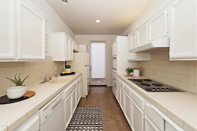 233 Lake Shore Dr, Rancho Mirage, CA 92270 - kitchen featuring a sink, under cabinet range hood, tile counters, white appliances, and white cabinets