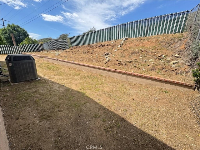 view of yard with fence and cooling unit