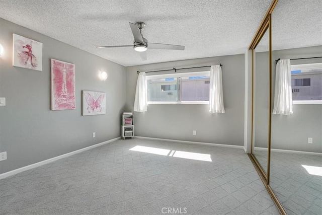 3649 Glendon Ave Unit 208, Los Angeles, CA 90034 - unfurnished bedroom featuring carpet, a closet, a textured ceiling, and ceiling fan