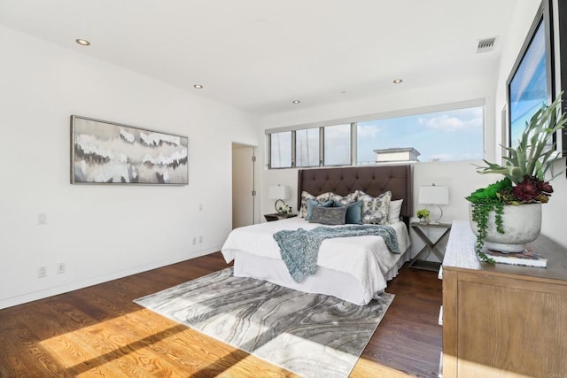 bedroom featuring baseboards, recessed lighting, wood finished floors, and visible vents