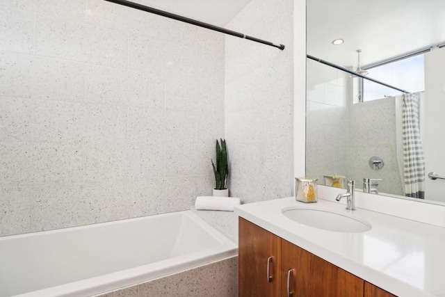 bathroom with a tub, vanity, and curtained shower