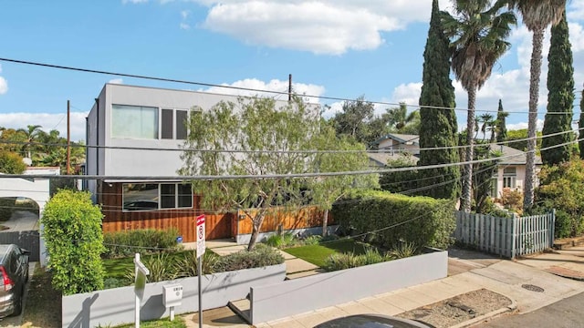 view of home's community featuring fence