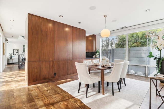 dining room featuring visible vents and light wood-type flooring