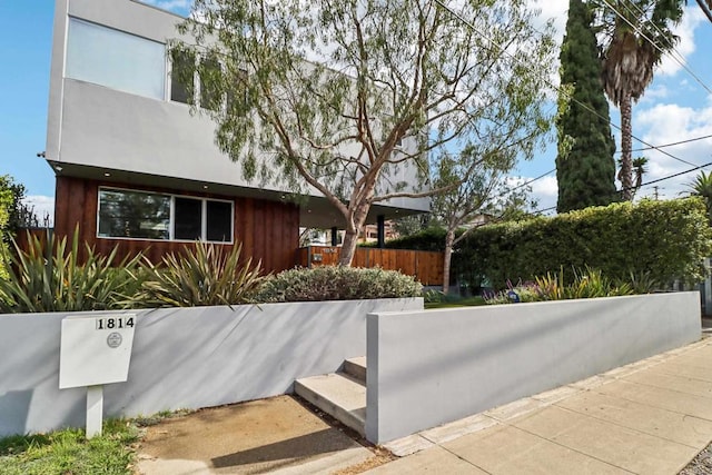 view of home's exterior with fence