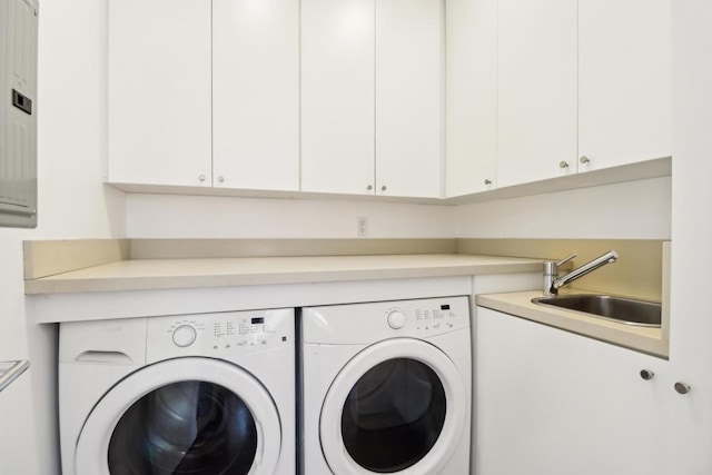 laundry area with a sink, washer and clothes dryer, and cabinet space
