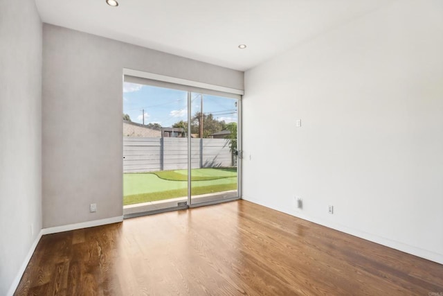 unfurnished room with recessed lighting, baseboards, and wood finished floors