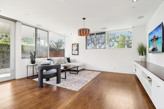 living room with baseboards, recessed lighting, and dark wood finished floors