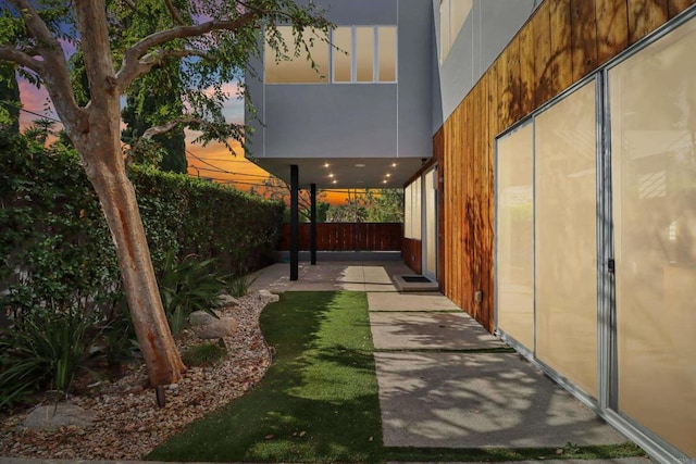 view of yard with fence and a patio