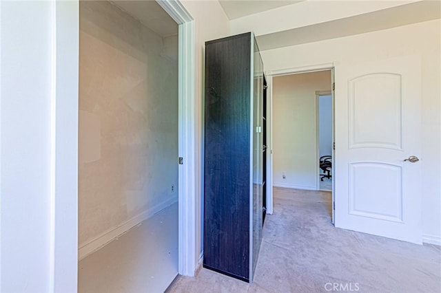hall featuring light colored carpet