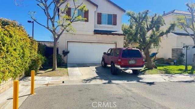 24854 Noelle, Newhall, CA 91321 - traditional-style home featuring driveway, stucco siding, and an attached garage