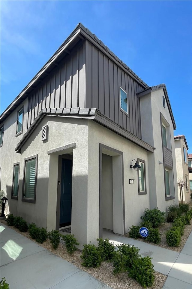 view of front facade with board and batten siding and stucco siding