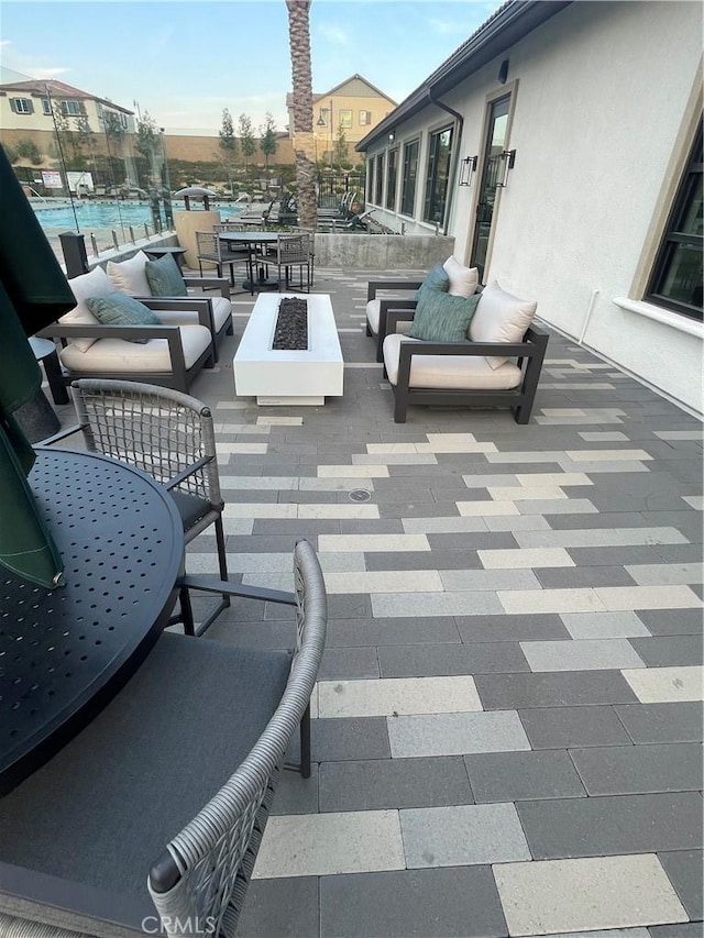 view of patio / terrace with an outdoor living space with a fire pit