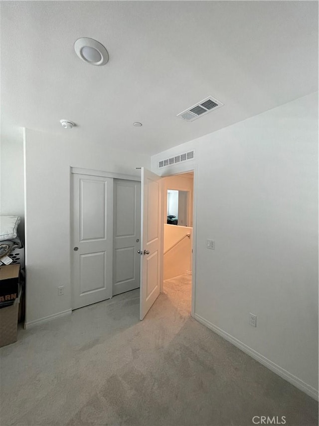 unfurnished room with carpet and baseboards