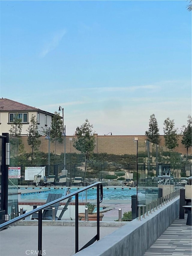 view of pool featuring fence
