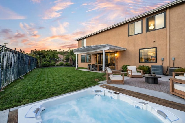 back of property at dusk featuring a patio area, cooling unit, stucco siding, an outdoor hot tub, and a pergola