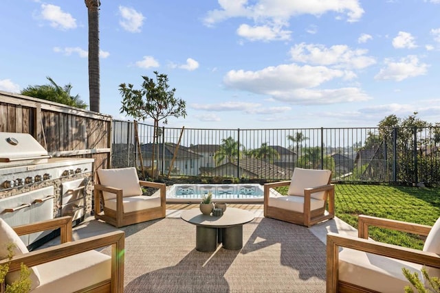 view of patio / terrace with a swimming pool, a fenced backyard, an outdoor kitchen, and outdoor lounge area