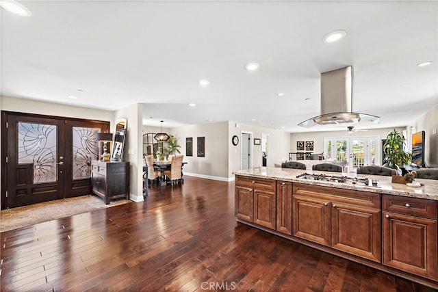 34501 Calle Carmelita, Dana Point, CA 92624 - kitchen with french doors, range hood, stainless steel gas stovetop, open floor plan, and dark wood-style flooring