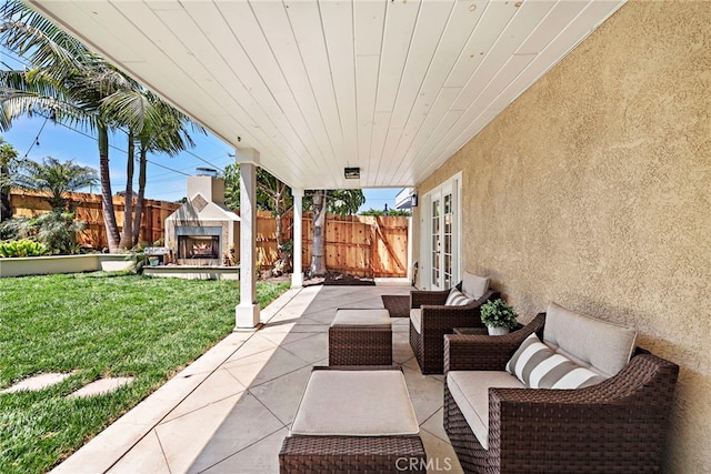 34501 Calle Carmelita, Dana Point, CA 92624 - view of patio / terrace with french doors, a fenced backyard, and an outdoor living space with a fireplace