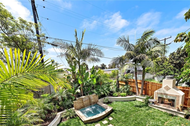 34501 Calle Carmelita, Dana Point, CA 92624 - view of yard featuring a warm lit fireplace and fence