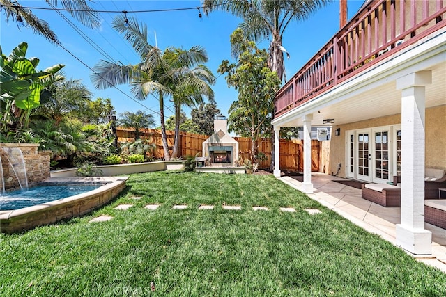 34501 Calle Carmelita, Dana Point, CA 92624 - view of yard with french doors, a lit fireplace, fence, and a patio area