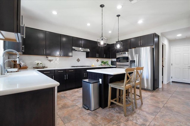 46525 Peach Tree St, Temecula, CA 92592 - kitchen with stainless steel fridge with ice dispenser, dark cabinets, under cabinet range hood, decorative backsplash, and recessed lighting
