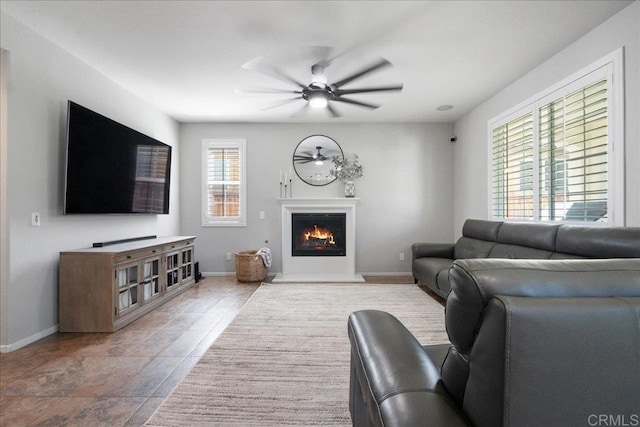46525 Peach Tree St, Temecula, CA 92592 - living room with a ceiling fan and a warm lit fireplace