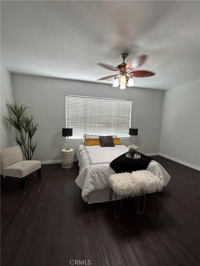 bedroom with baseboards, wood finished floors, and a ceiling fan