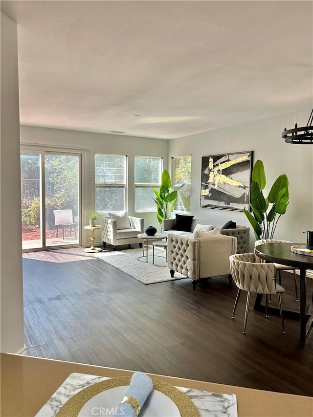 living room with a chandelier and wood finished floors