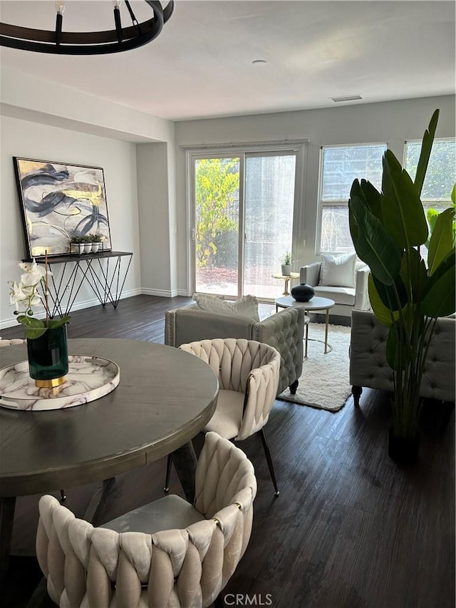 dining area featuring baseboards, dark wood-style floors, and visible vents