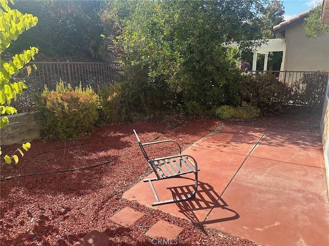 view of patio featuring fence