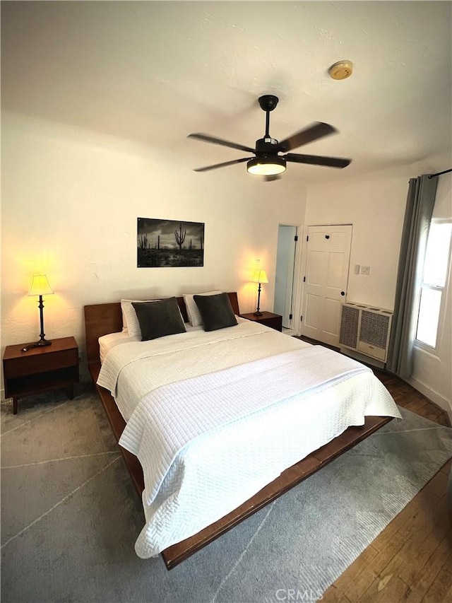 bedroom with dark wood-style floors and ceiling fan