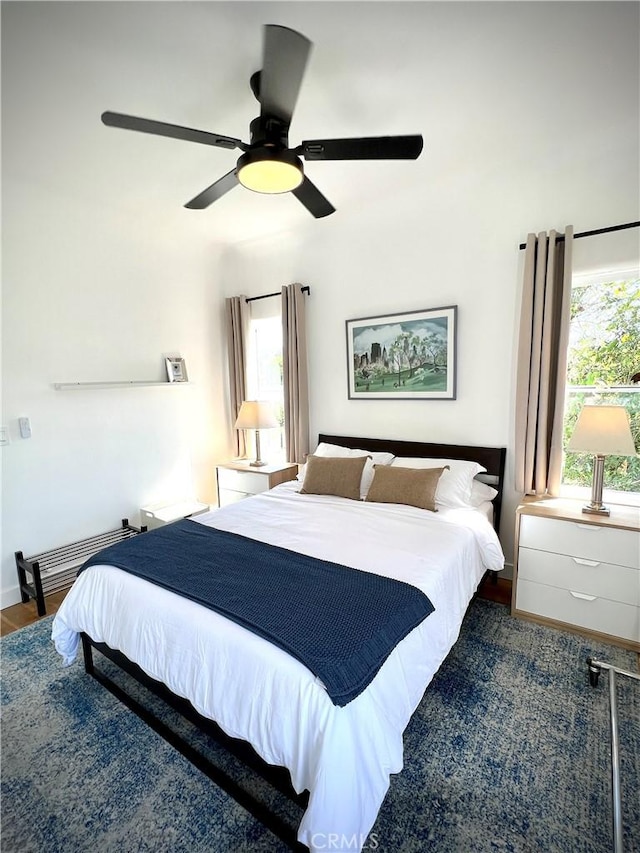 bedroom with a ceiling fan and wood finished floors