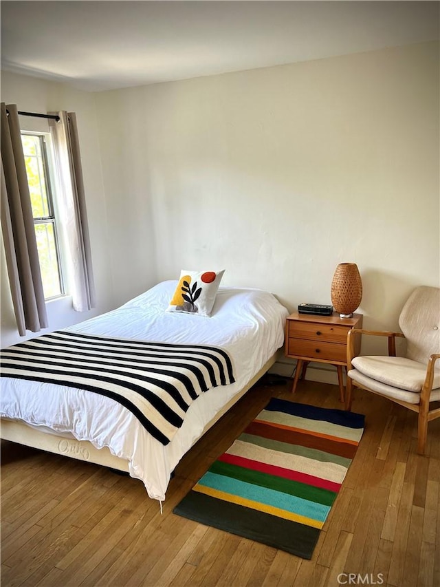bedroom with hardwood / wood-style flooring