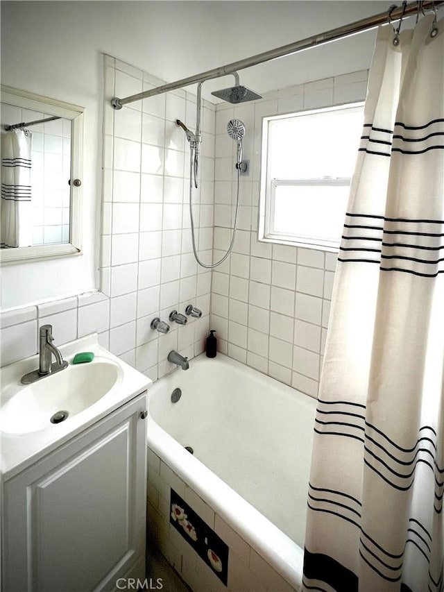 full bath with shower / tub combo with curtain, vanity, and tasteful backsplash