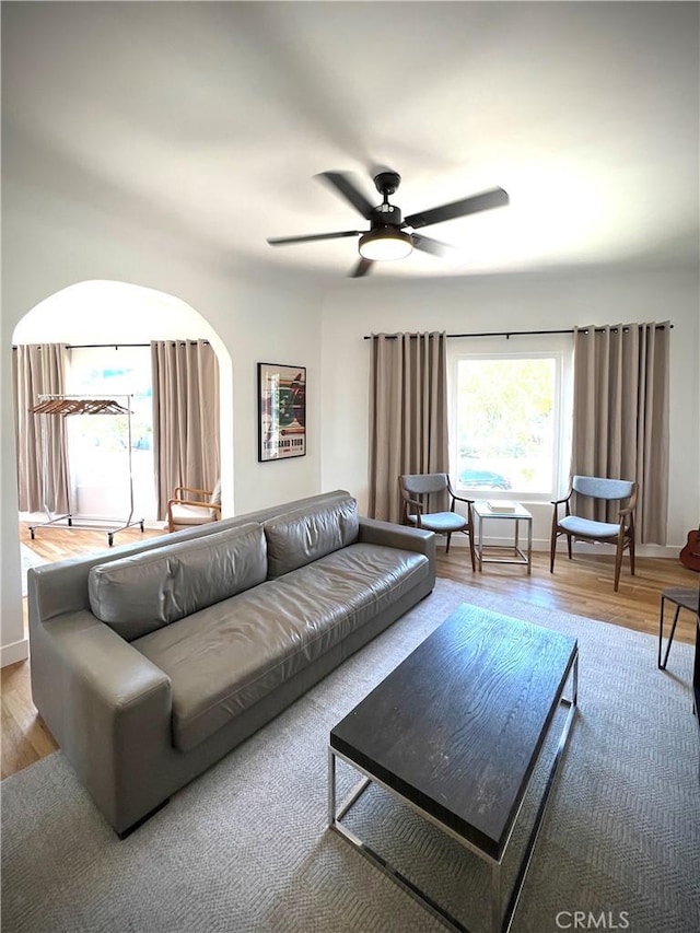 living area with wood finished floors and ceiling fan