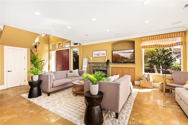 living room featuring recessed lighting, a fireplace, and ornamental molding