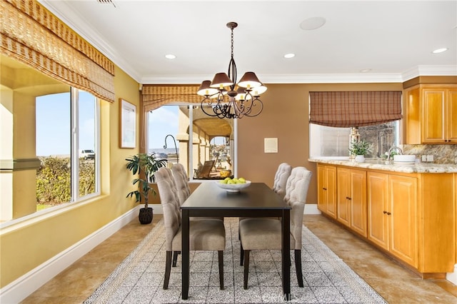 dining room with baseboards, a healthy amount of sunlight, a chandelier, and recessed lighting