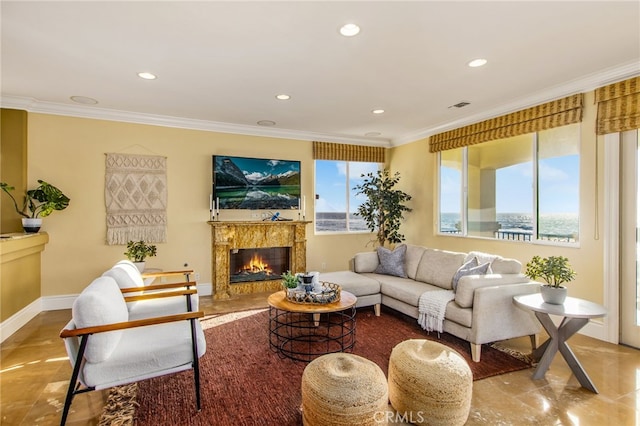 living area with a fireplace, visible vents, recessed lighting, and crown molding