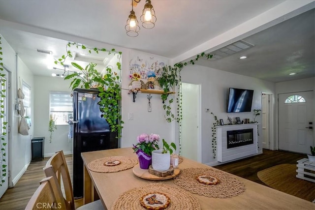 201 E Olive St, San Bernardino, CA 92410 - dining space with a glass covered fireplace, visible vents, recessed lighting, baseboards, and wood finished floors