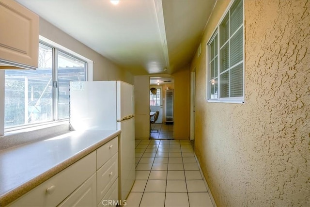 201 E Olive St, San Bernardino, CA 92410 - hallway featuring a wealth of natural light and light tile patterned floors