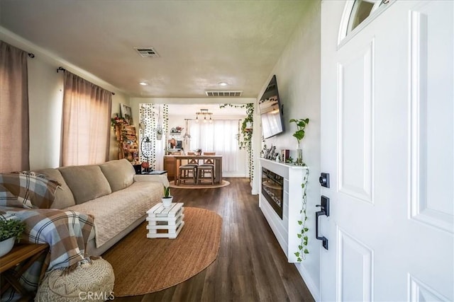 201 E Olive St, San Bernardino, CA 92410 - living area featuring a glass covered fireplace, dark wood-type flooring, and visible vents